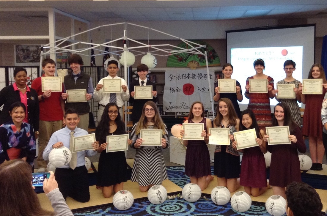 students holding their certificates